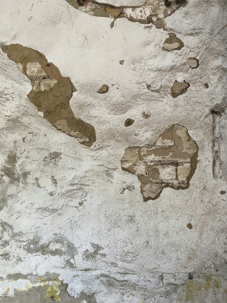 Cracked and peeling wall surface for painting or repair work.